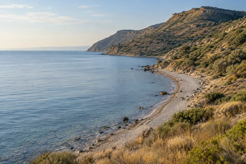 The quiet shoreline of Anzac Cove and the ridges above it on the Gallipoli Peninsula