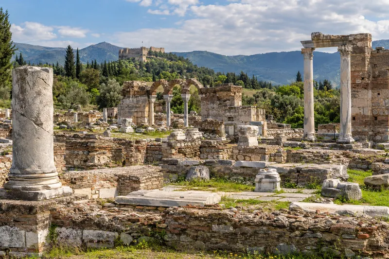 The ruins of the Basilica of St. John in Selcuk with Ayasuluk Castle on the hill behind