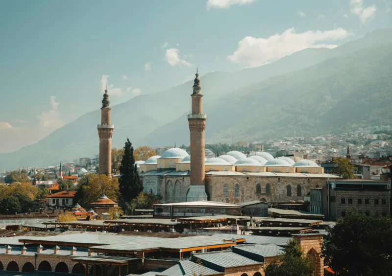 The Grand Mosque (Ulu Cami) of Bursa with its two minarets and many domes, Mount Uludağ behind