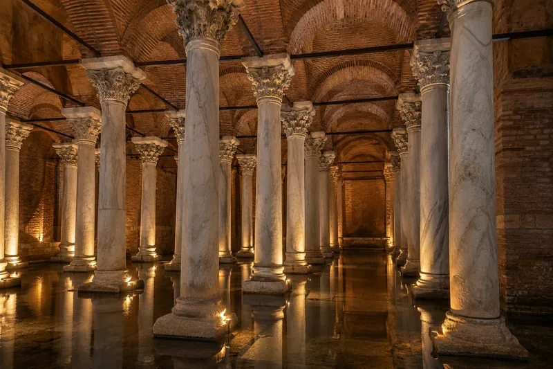 Softly lit marble columns and brick vaults of a Byzantine cistern in Istanbul