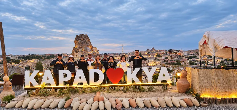 Turkey Itineraries guests. Evening below Uçhisar Castle, Cappadocia