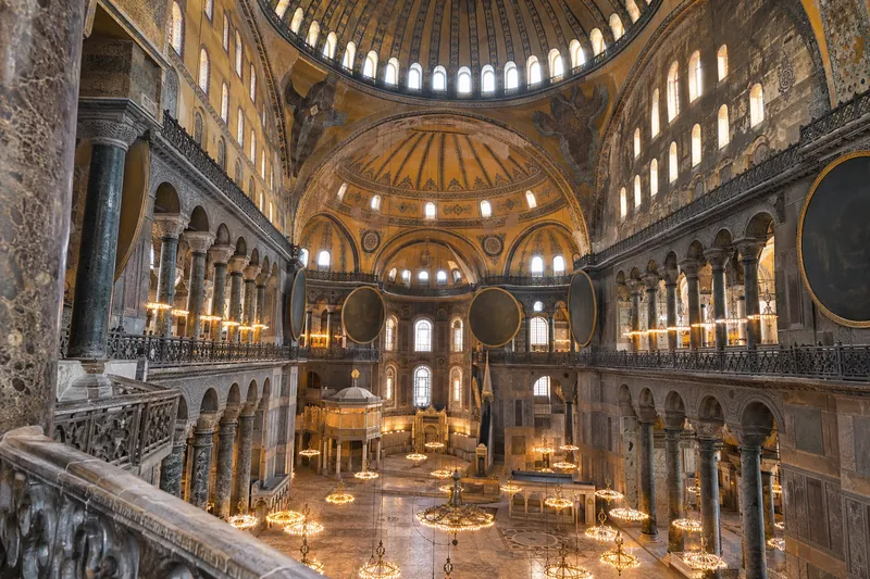 The vast dome and chandeliers of Hagia Sophia seen from the upper gallery, Istanbul