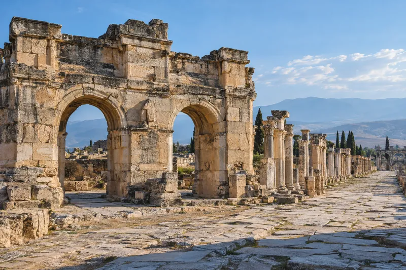 The arched Frontinus Gate and colonnaded street of Hierapolis above Pamukkale