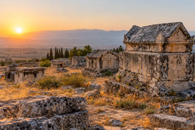 Ancient tombs and sarcophagi in the necropolis of Hierapolis near Pamukkale at sunset