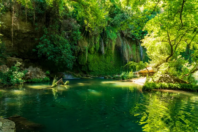The Kurşunlu waterfall near Antalya falling into a green pool under the forest
