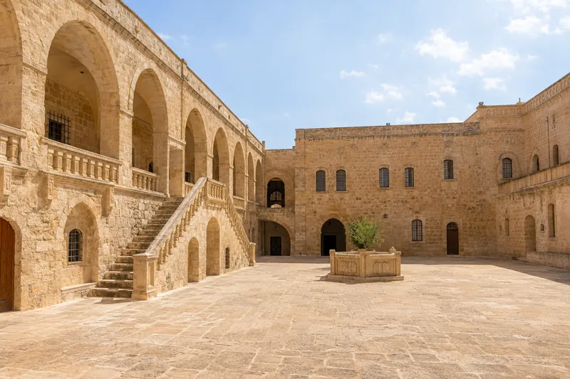 The honey-colored stone courtyard of the Syriac Mor Gabriel Monastery near Midyat