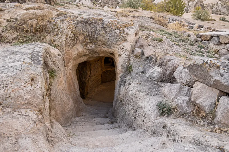 The carved stone entrance and steps of the Ozkonak underground city, Cappadocia