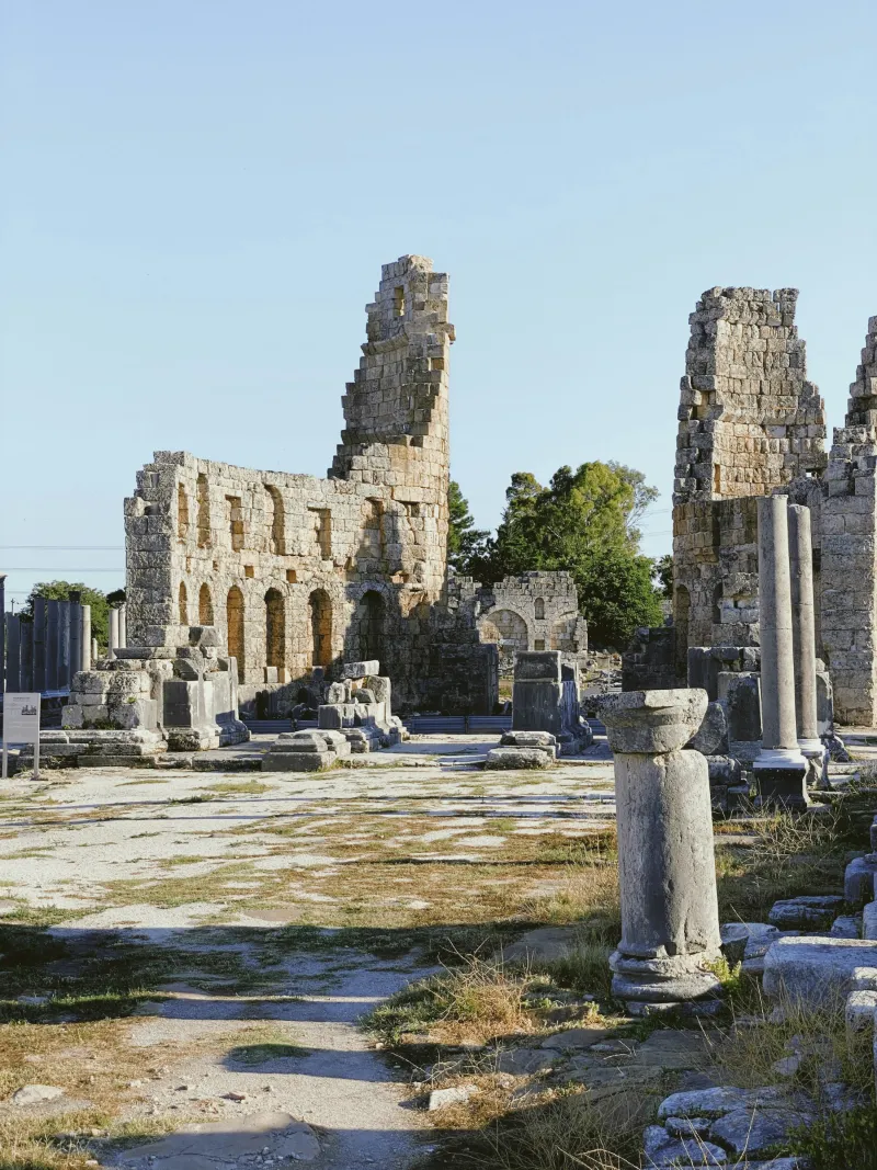 Columns and high walls among the ruins of Perge, a Roman city near Antalya