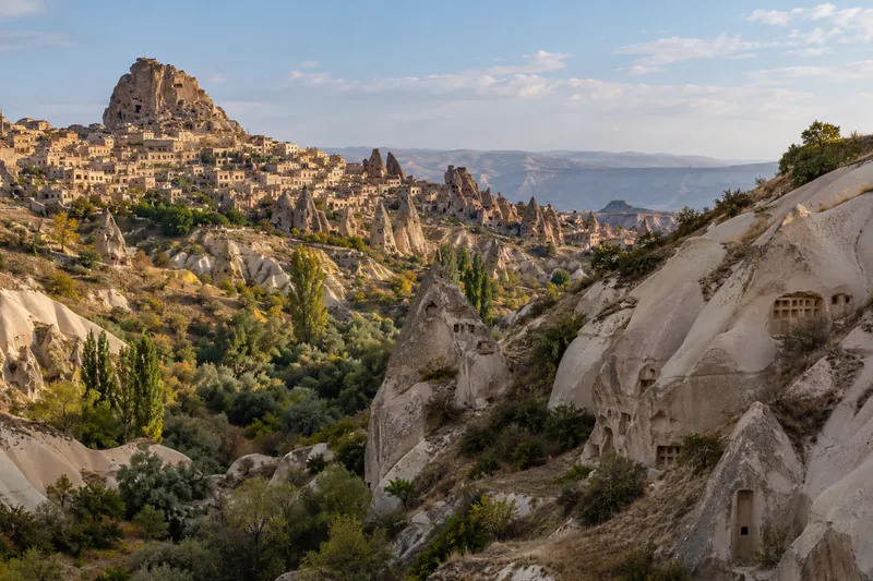 Pigeon Valley with carved dovecotes and Uchisar Castle above, Cappadocia