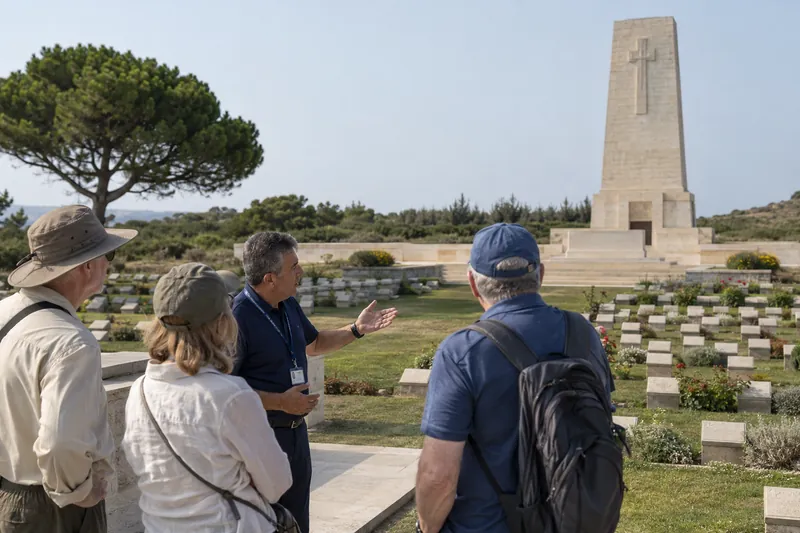 A licensed guide speaking to travelers at the Lone Pine cemetery and memorial, Gallipoli